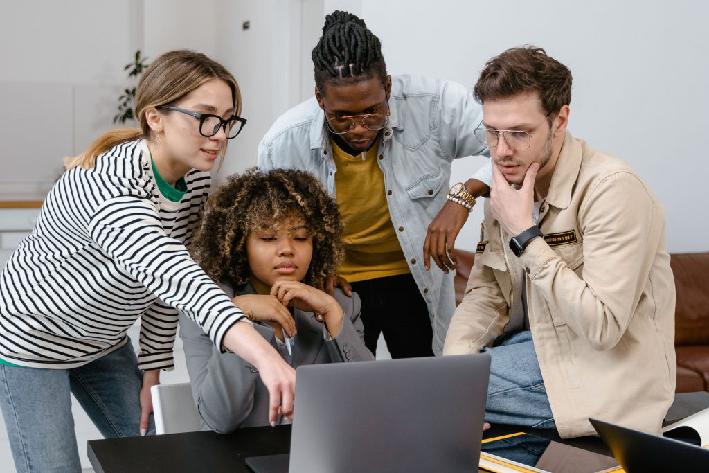 young people around laptop
